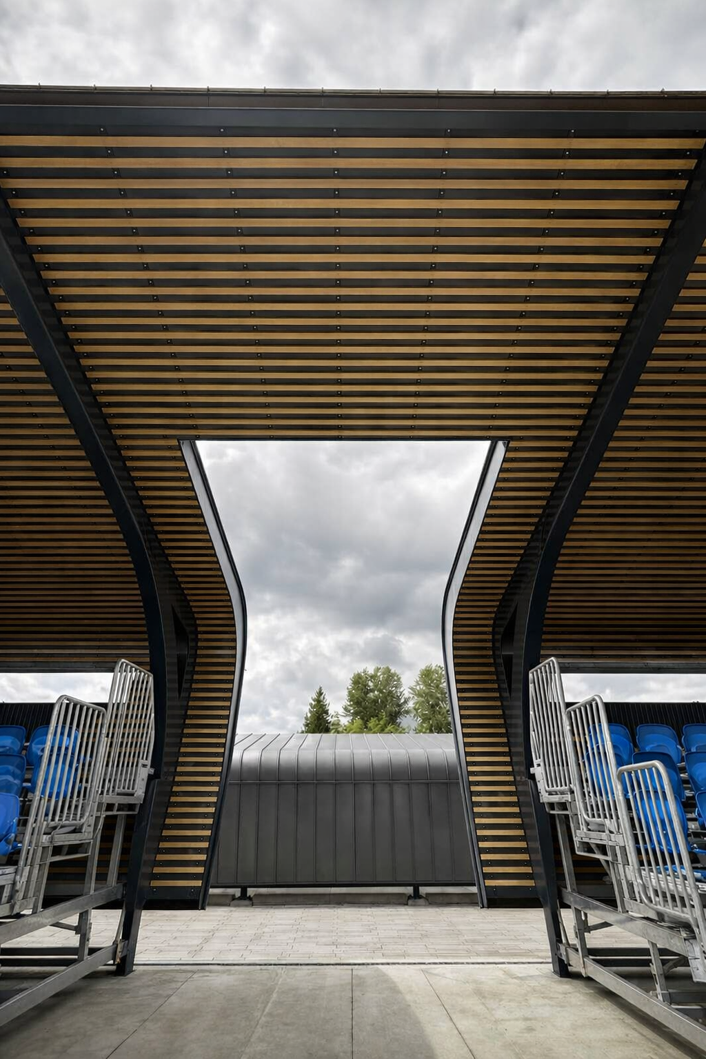 Wood-slat canopy entrance between grandstands