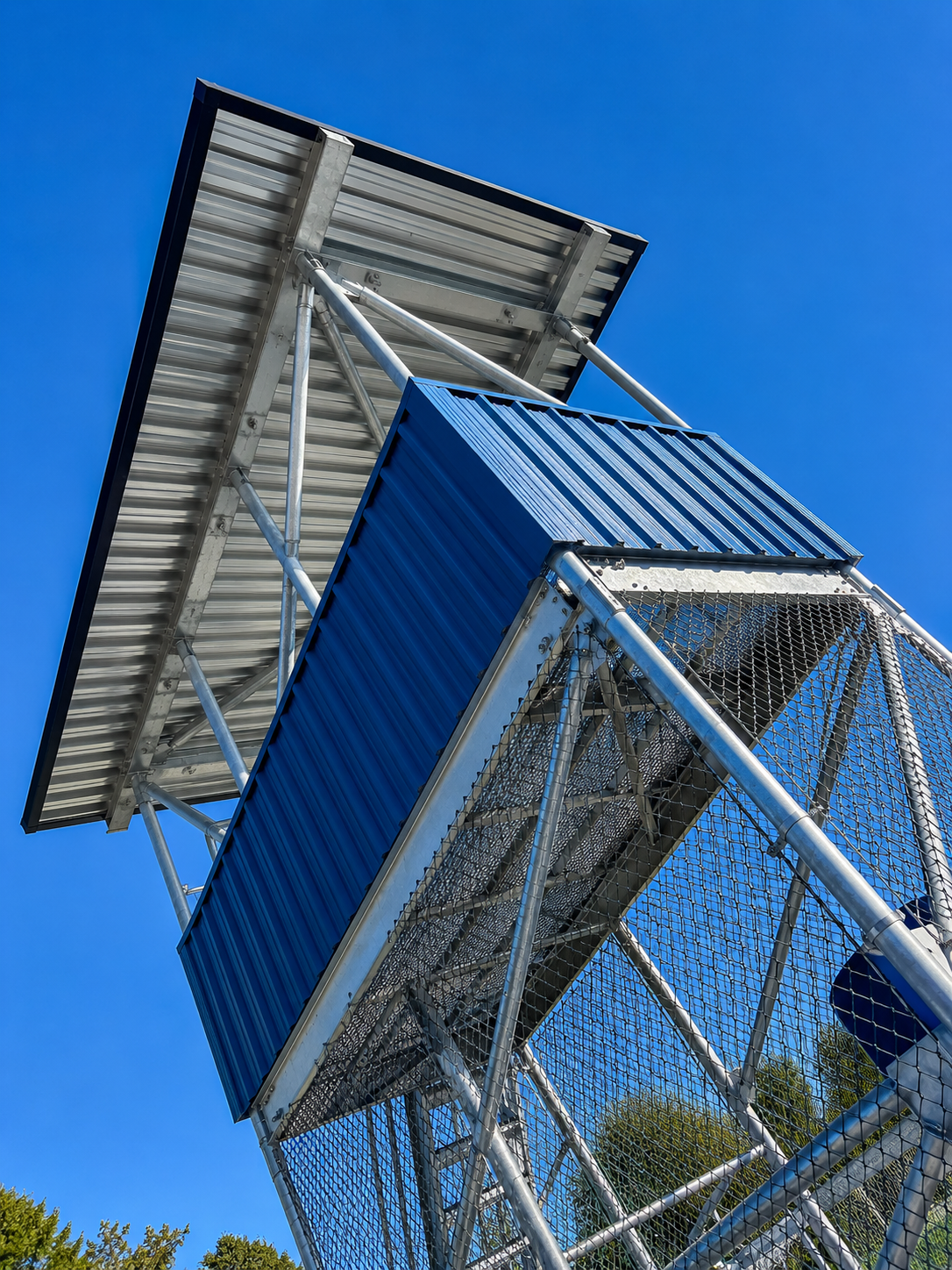 Spotter tower with blue corrugated cladding at sports park