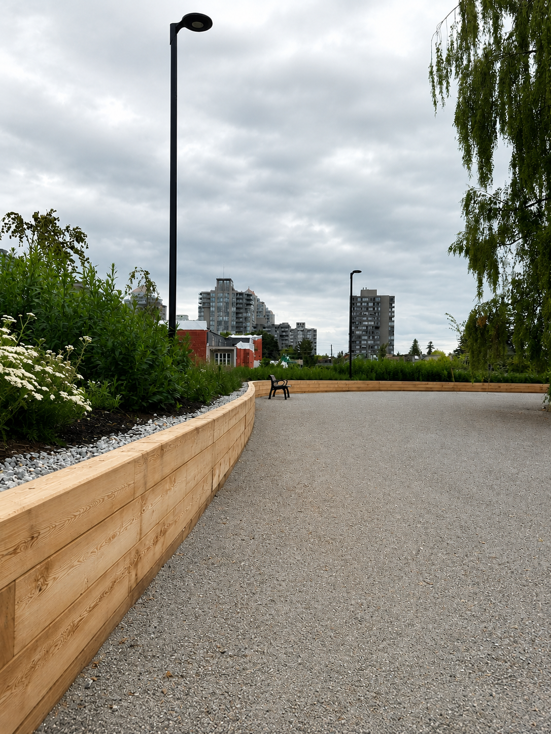 Curved timber retaining wall with landscaped path